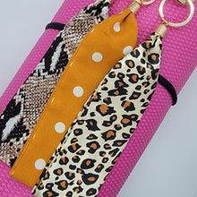 Load image into Gallery viewer, These swank keychains are functional and spirited! Show off your fun personality! No reason to carry your whole purse to class or the gym. Simply slip the soft fabric over your wrist and your keys/key cards/card wallet are at your fingertips in seconds. In addition to the split ring, these key chains also have a detachable key ring, with a tag charm you can personalize, for added convenience.   3 fabrics - Brown snake skin, Mustard white polka dot & Leopard