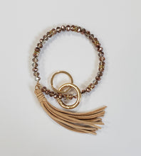 Load image into Gallery viewer, Bracelet keychain is 10" and includes a detachable key ring and a decorative tassel.  Comes in white/gold, black/gold and copper/gold.
