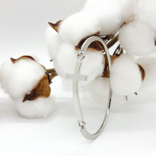 Load image into Gallery viewer, This beautiful cross cuff bracelet is a welcome piece at any occasion! It is delicate enough in appearance to wear for a formal event & durable enough to wear camping. The bracelet latches by using the cross charm, which is a unique feature.