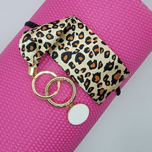 Load image into Gallery viewer, These swank keychains are functional and spirited! Show off your fun personality! No reason to carry your whole purse to class or the gym. Simply slip the soft fabric over your wrist and your keys/key cards/card wallet are at your fingertips in seconds. In addition to the split ring, these key chains also have a detachable key ring, with a tag charm you can personalize, for added convenience.   3 fabrics - Brown snake skin, Mustard white polka dot & Leopard