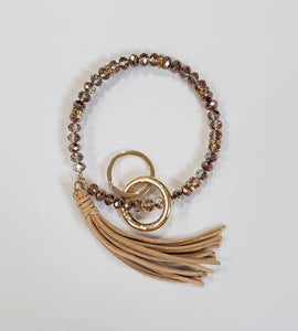 Bracelet keychain is 10" and includes a detachable key ring and a decorative tassel.  Comes in white/gold, black/gold and copper/gold.