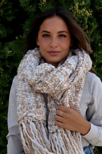 This scarf is ivory/cream based with tan tones mixed throughout and the fringe is absolutely flattering.