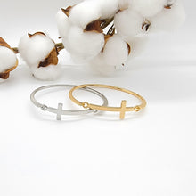 Load image into Gallery viewer, This beautiful cross cuff bracelet is a welcome piece at any occasion! It is delicate enough in appearance to wear for a formal event &amp; durable enough to wear camping. The bracelet latches by using the cross charm, which is a unique feature.
