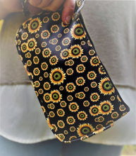 Load image into Gallery viewer, Clutch 5&quot; x 8-1/4&quot; with matching zipper tag and wrist handle. 4 prints available Black Snakeskin, Brown Snakeskin, Leopard and Black with Yellow flowers.
