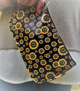 Clutch 5" x 8-1/4" with matching zipper tag and wrist handle. 4 prints available Black Snakeskin, Brown Snakeskin, Leopard and Black with Yellow flowers.