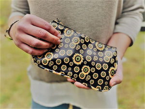 Clutch 5" x 8-1/4" with matching zipper tag and wrist handle. 4 prints available Black Snakeskin, Brown Snakeskin, Leopard and Black with Yellow flowers.