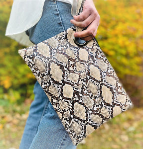 Grand Clutch 8-3/4" x 12" Zipper closure Matching wrist strap 3 interior pockets 2 prints Brown Snakeskin and Leopard