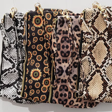 Load image into Gallery viewer, Clutch 5&quot; x 8-1/4&quot; with matching zipper tag and wrist handle. 4 prints available Black Snakeskin, Brown Snakeskin, Leopard and Black with Yellow flowers.
