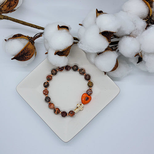 You can feel the warmth of this bracelet in each bead. The earth tone & gold accent beads compliment the ivory cross & orange heart perfectly. Give the love of the cross to someone who needs to be comforted or reassured with this bracelet.