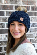 Load image into Gallery viewer, This Navy Chenille Beanie absolutely draws attention! You don&#39;t even need to touch this beanie to see how soft, comfortable &amp; warm (fleece lining) it is. And the faux fur pom adds the right amount of Sas! 
