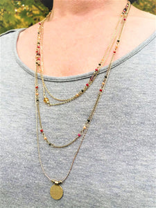 This delicate layered charm and beaded necklace will bring the warmth this fall. The colors of the beads are warm yellow, red, purple and blue which bring out the rose gold hue in the necklace. The full length is 14.5".