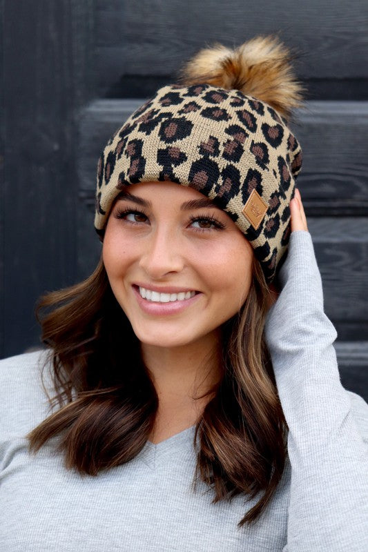 Leopard beanie 100% soft acrylic knit with faux fur pom. 