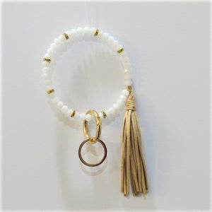 Bracelet keychain is 10" and includes a detachable key ring and a decorative tassel.  Comes in white/gold, black/gold and copper/gold.